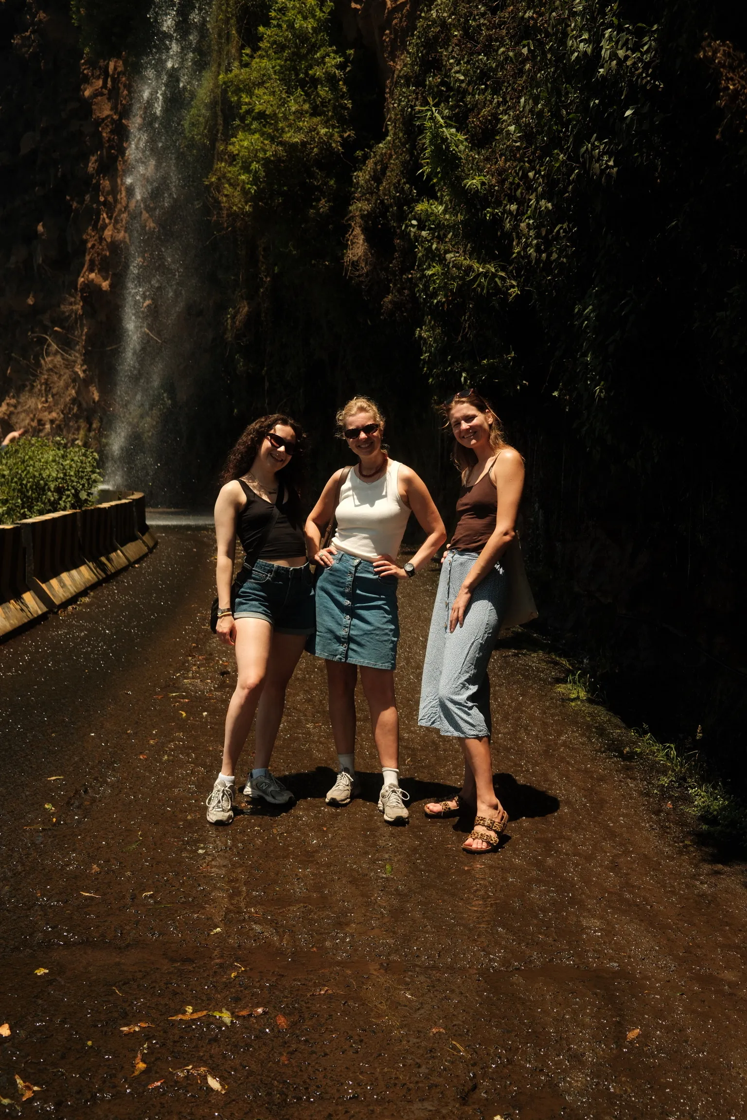 Residents on a levada trail by a waterfall