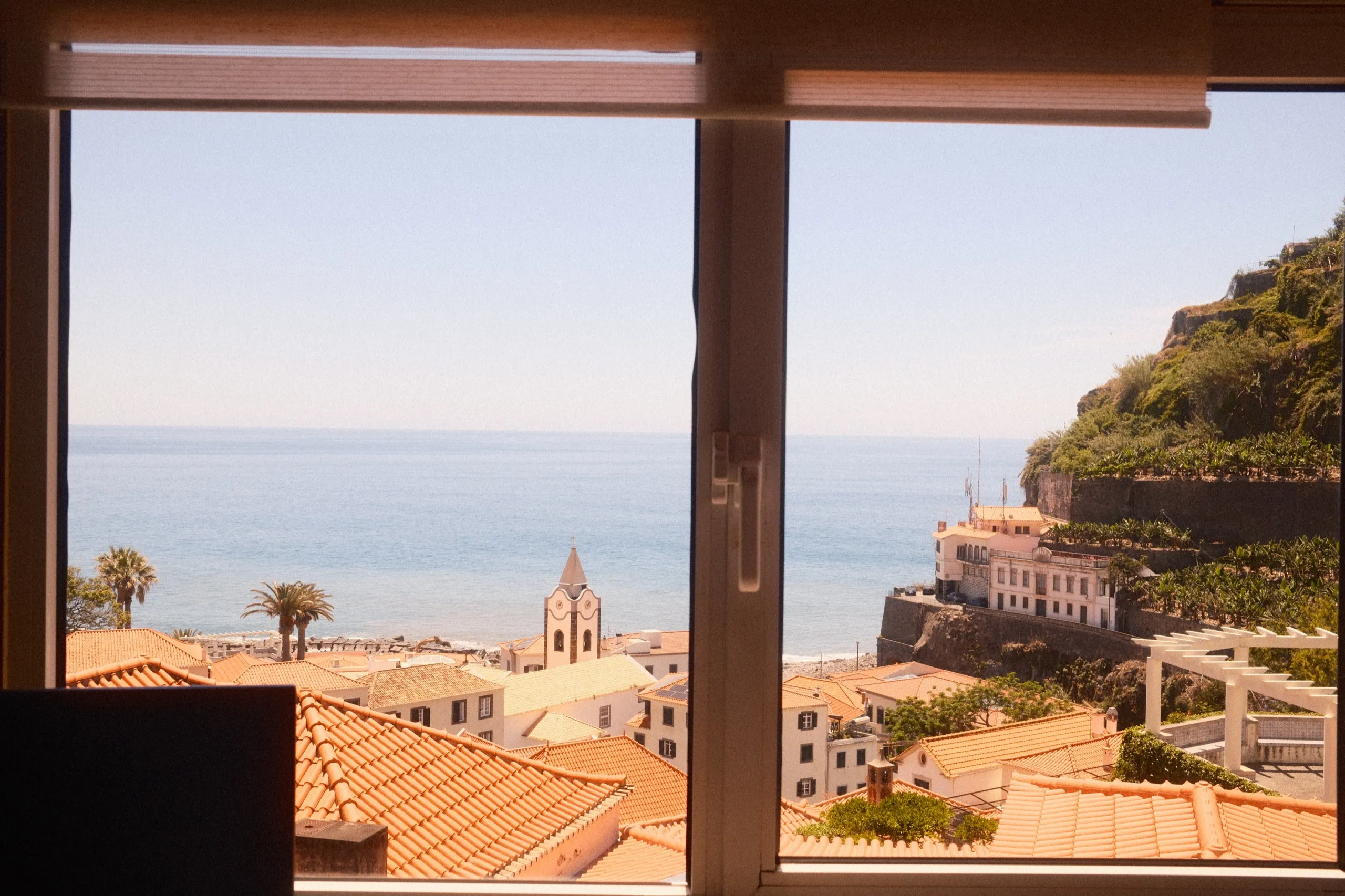 Ocean and church-tower view from a bedroom window